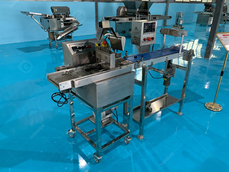 Chocolate covering machine with adjustable coating thickness