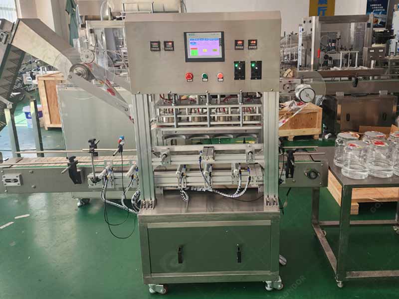 aluminium foil sealing machine for plastic bottle caps in a factory setting